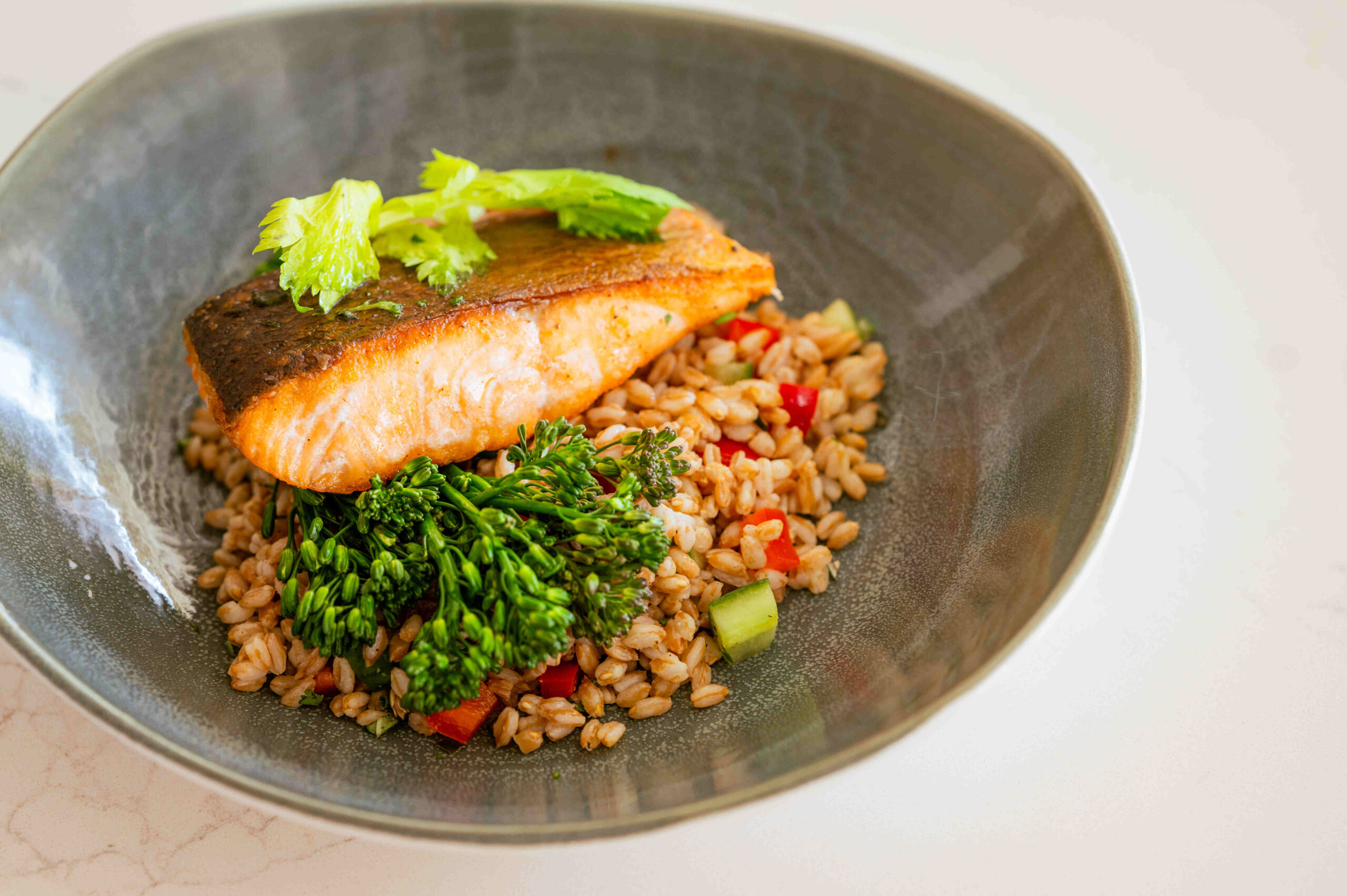 plate with salmon and lemon and tarragon farro salad