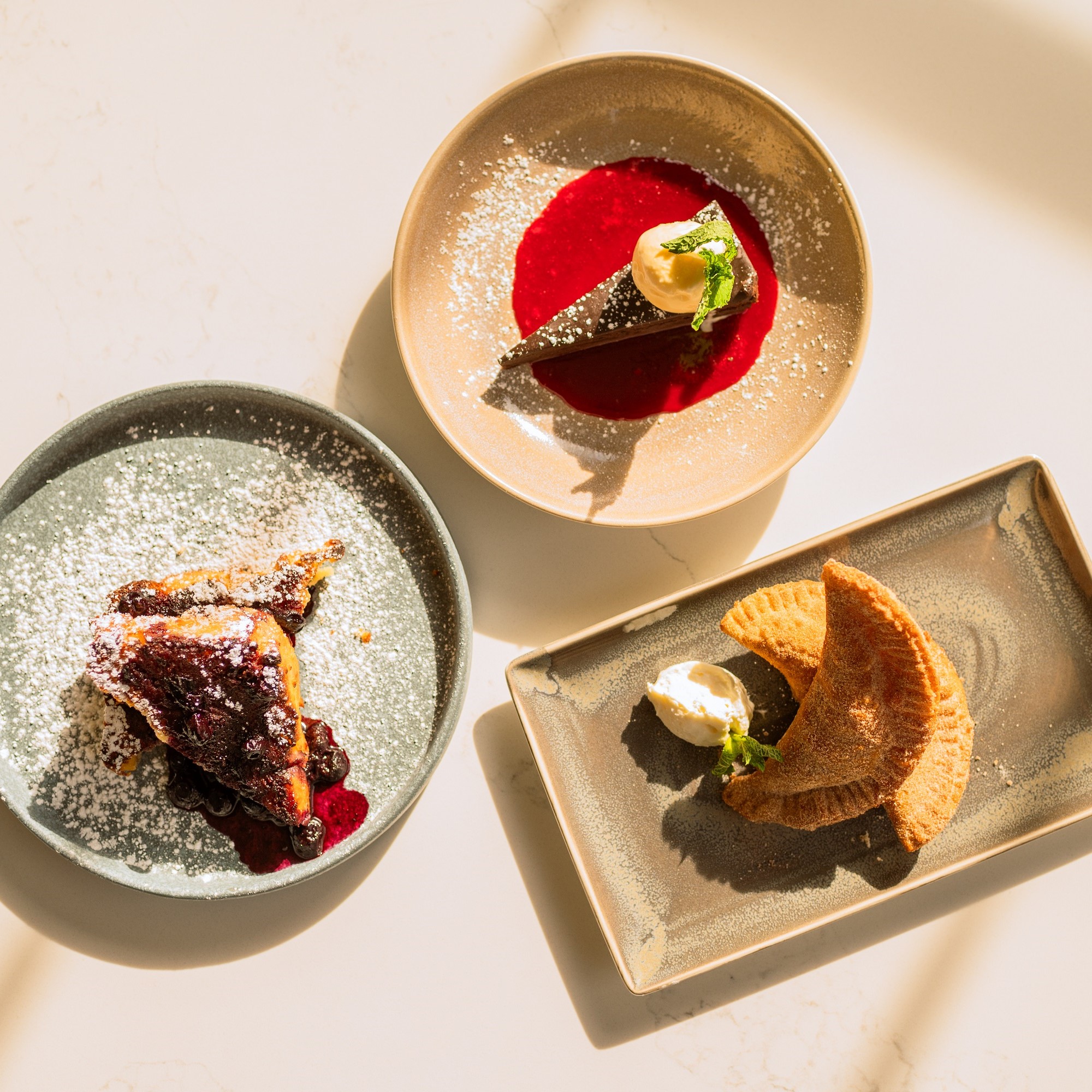 three plated desserts on table